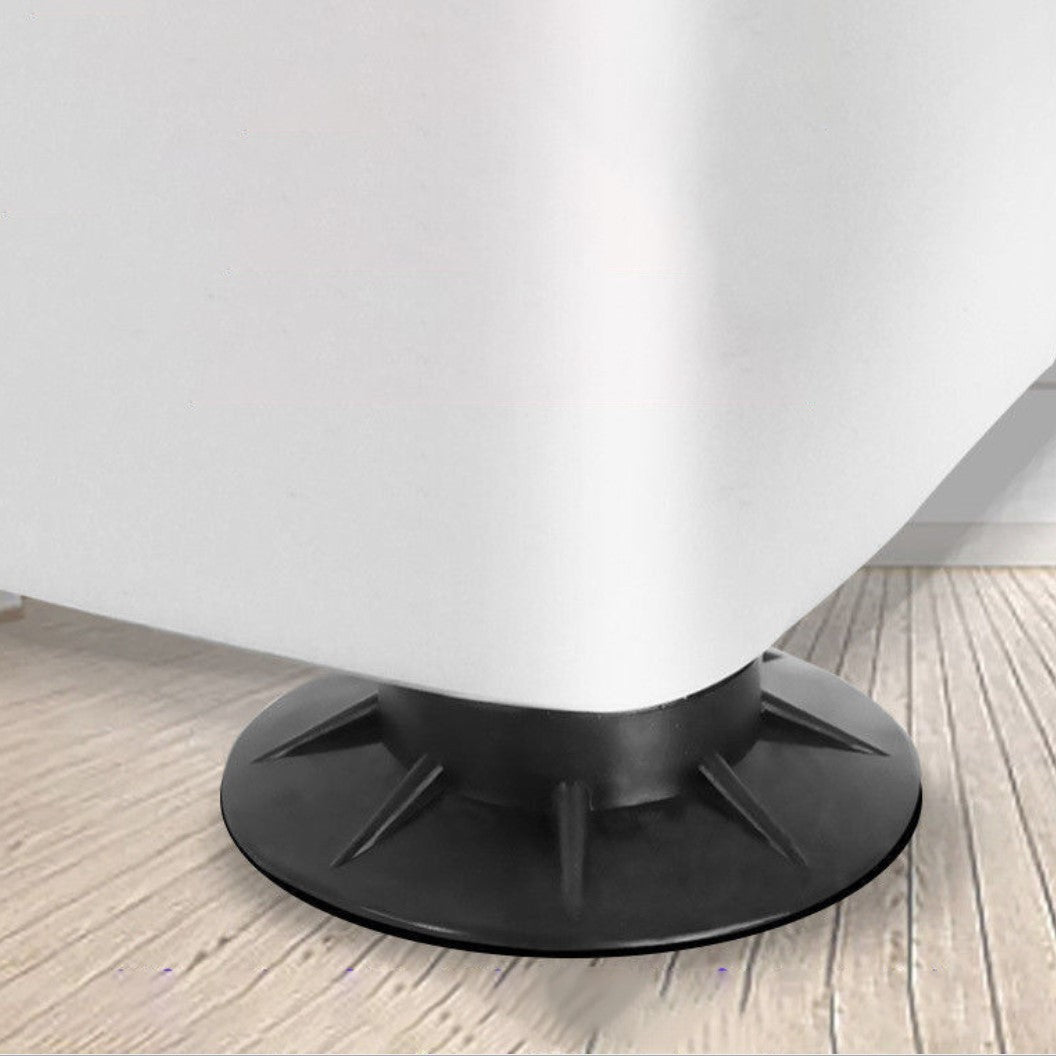 Dettaglio della base circolare nera di un mobile bianco su pavimento in legno chiaro